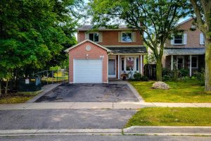 Suburban house with driveway and garage front view.