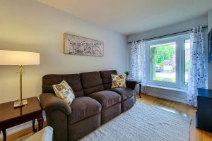 Cozy living room with brown sofa and window view.