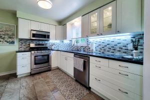 Modern kitchen with stainless steel appliances and cabinets.