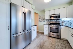 Modern kitchen with stainless steel appliances and cabinets.