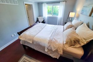 Cozy bedroom with white bed and natural light