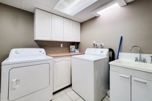 Laundry room with washer, dryer, and sink.