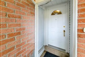 White door with brick walls entrance