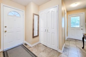 Bright hallway with doors and wall mirror