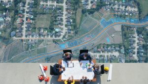 Aerial view of suburb with overlay map showing proposed new road routes and planning documents