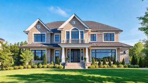 Large two-story brick house with manicured lawn.
