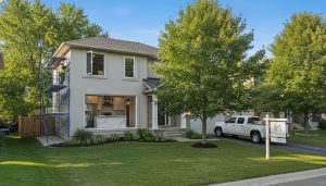 Milton Ontario suburban house mid-renovation with contractors and a For Sale sign