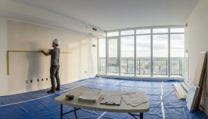 Milton condo interior during renovation with contractor and condo documents on table