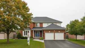 Georgetown Ontario home with new roof and For Sale sign on front lawn
