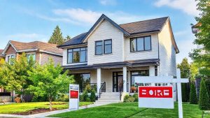 Modern two-story house for sale with sign.