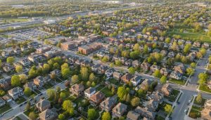 Aerial view of residential neighborhood in Georgetown, Ontario with houses, trees, and a nearby GO station.